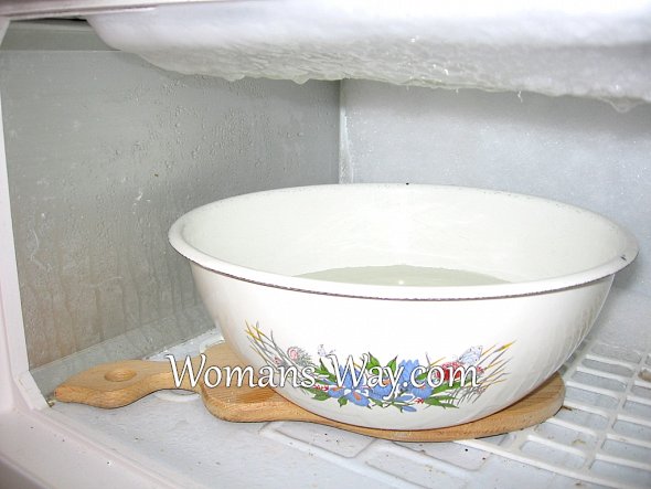Миска с горячей водой для ускоренного таяния льда внутри морозильной камеры